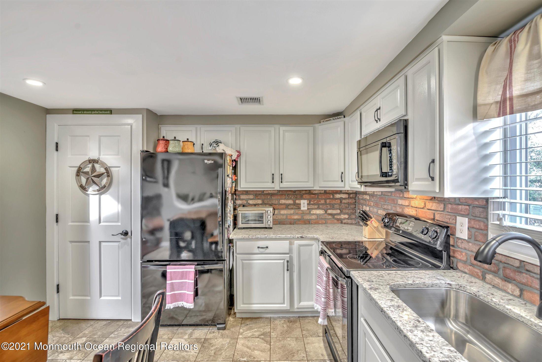 412 Conifer Drive Forked River, NJ 08731 - Photo 19 of 37 a kitchen with a sink stove and refrigerator