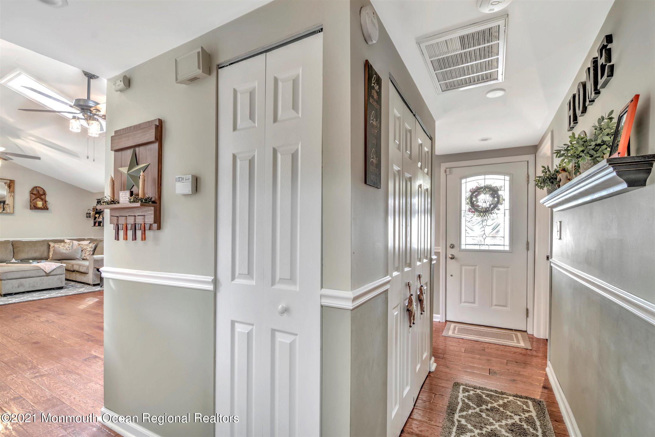 412 Conifer Drive Forked River, NJ 08731 - Photo 3 of 37 a view of a hallway with a dining table a chandelier and entryway