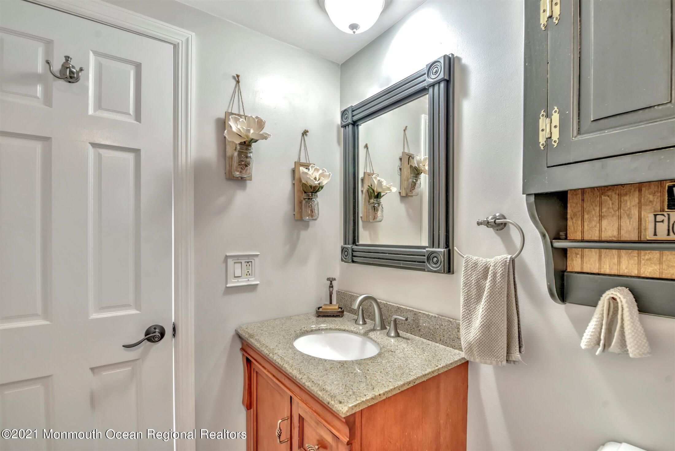 412 Conifer Drive Forked River, NJ 08731 - Photo 21 of 37 a bathroom with a granite countertop sink vanity and mirror