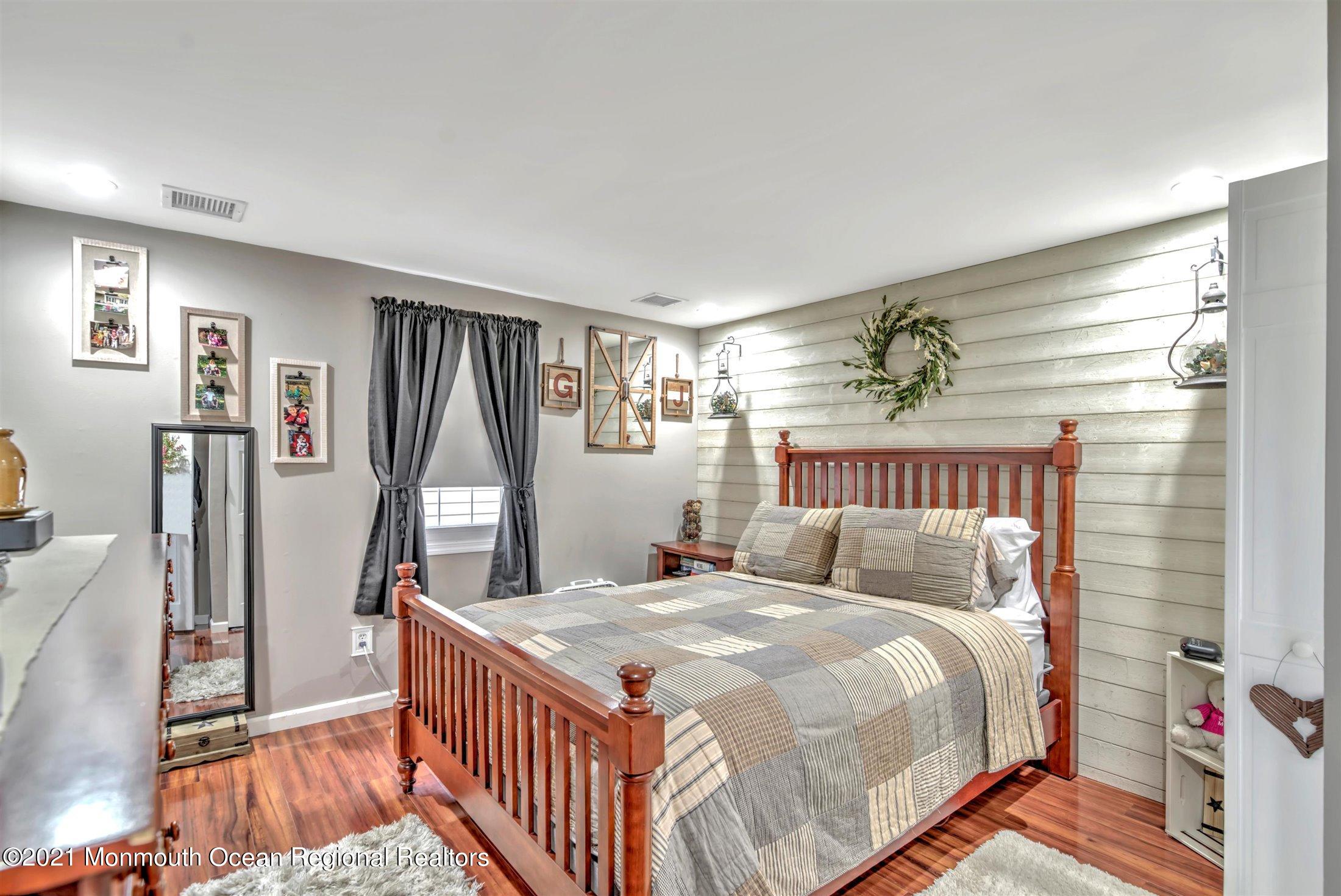 412 Conifer Drive Forked River, NJ 08731 - Photo 23 of 37 a bed sitting in a bedroom next to a window