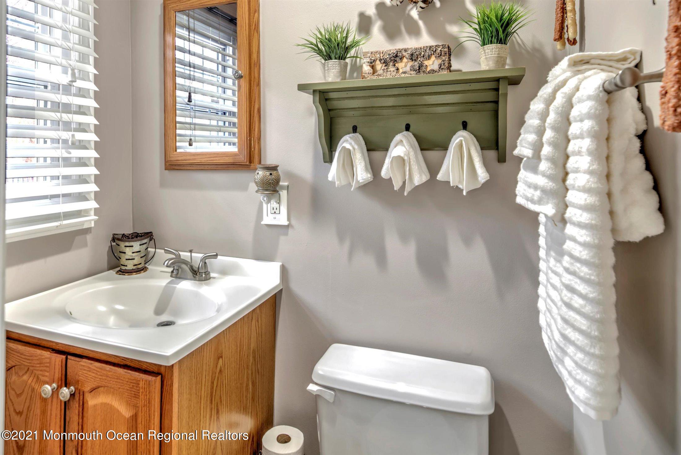 412 Conifer Drive Forked River, NJ 08731 - Photo 24 of 37 a bathroom with a sink vanity mirror and toilet