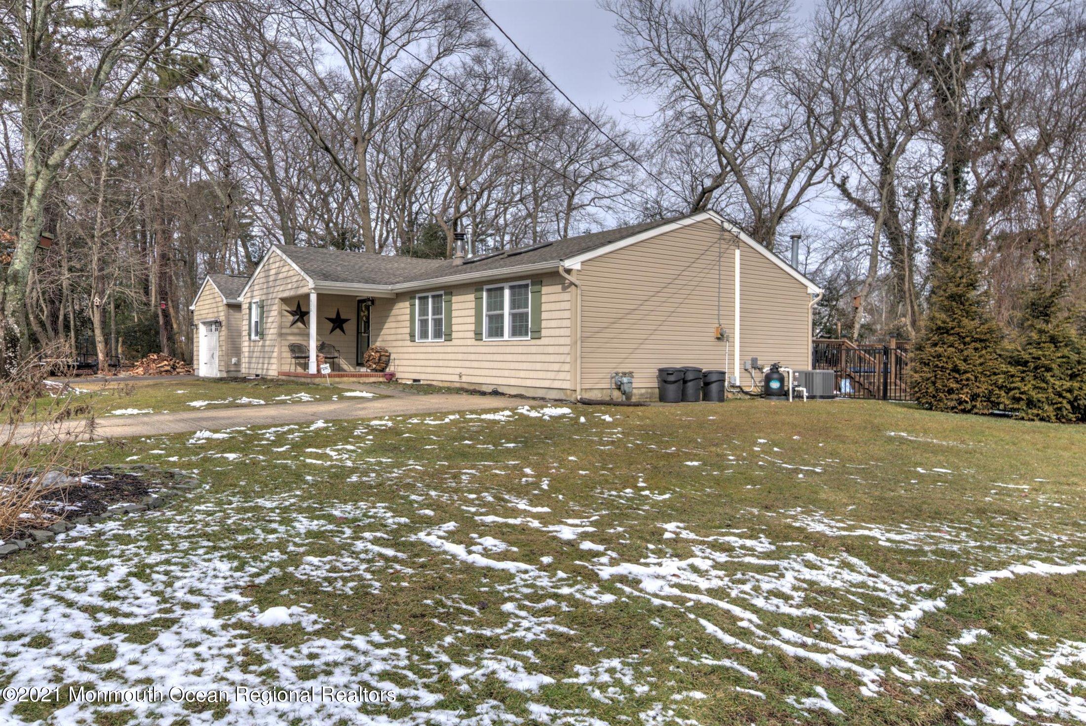 412 Conifer Drive Forked River, NJ 08731 - Photo 37 of 37 a view of a yard in front of a house with large trees