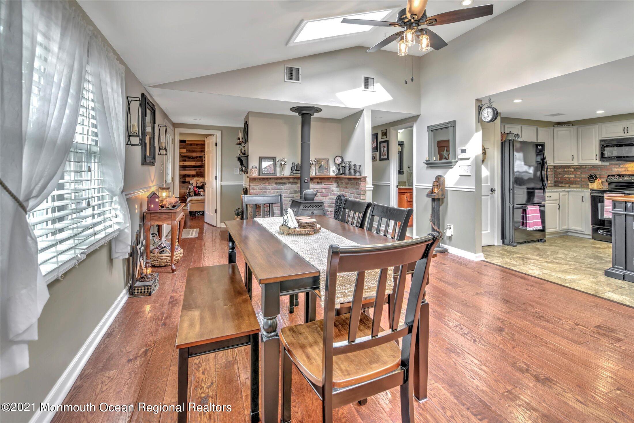 412 Conifer Drive Forked River, NJ 08731 - Photo 6 of 37 a view of a dining room with furniture and wooden floor