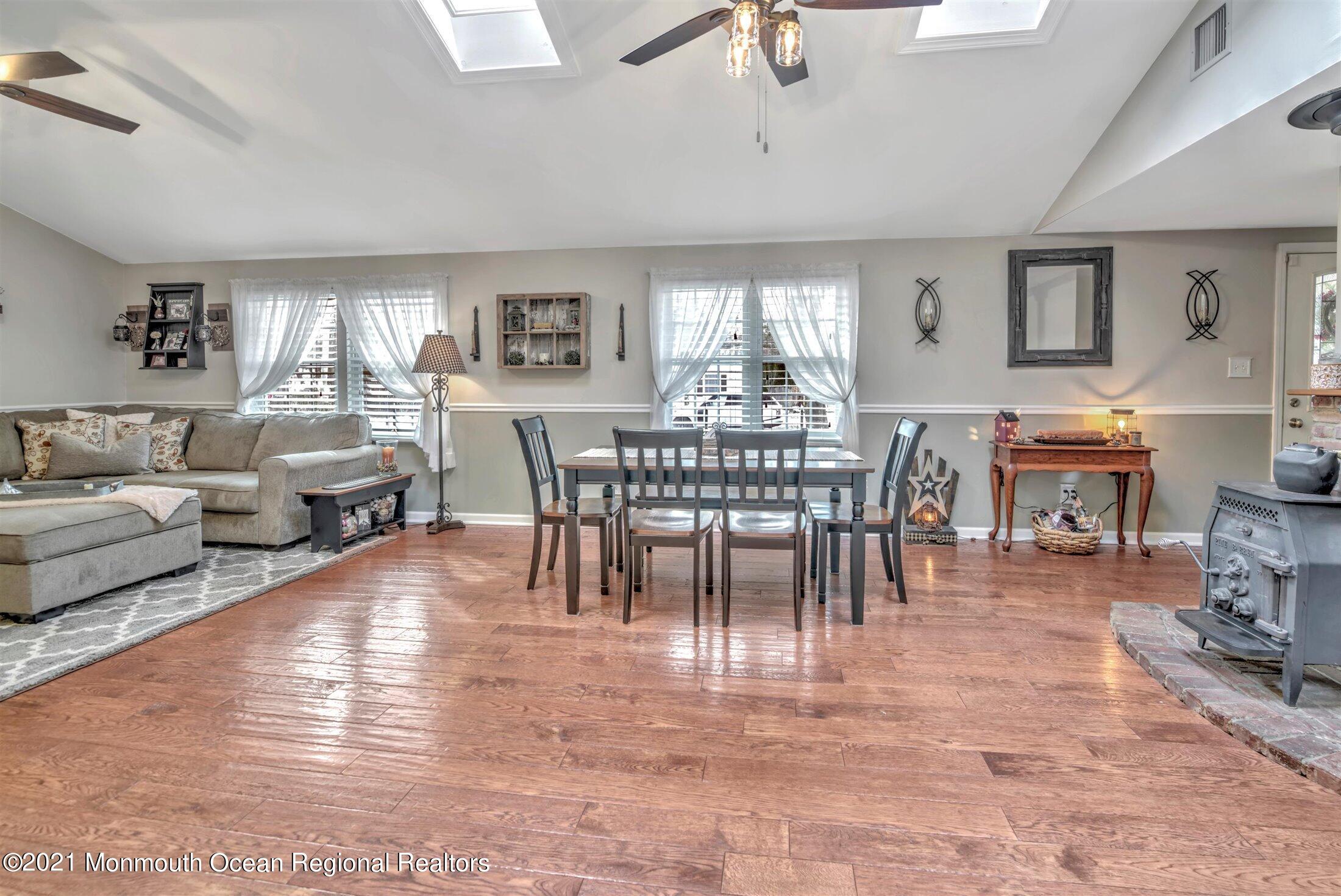 412 Conifer Drive Forked River, NJ 08731 - Photo 9 of 37 a view of a dining room with furniture window and wooden floor