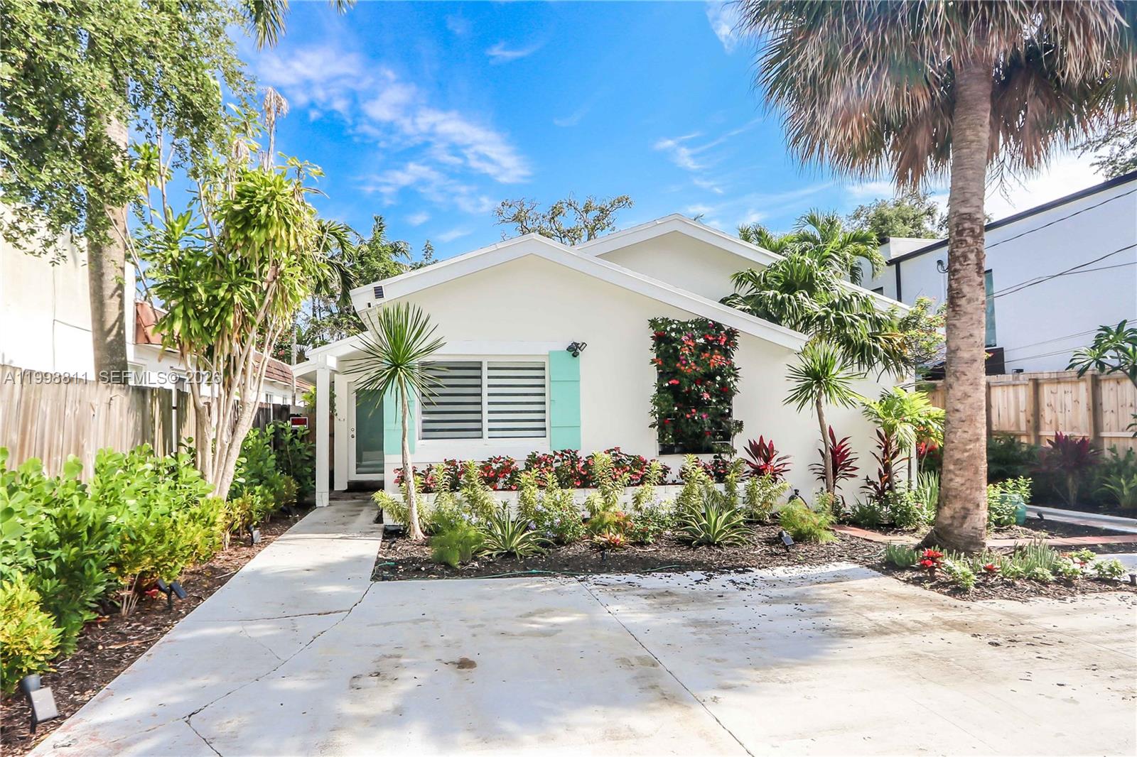 3155 Jackson Avenue Miami, FL 33133 - Photo 1 of 20 a front view of a house with garden