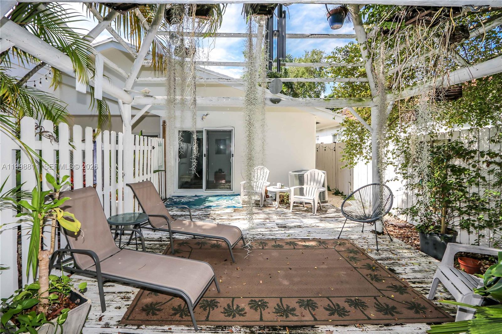 3155 Jackson Avenue Miami, FL 33133 - Photo 19 of 20 a view of a patio with couches table and chairs and potted plants