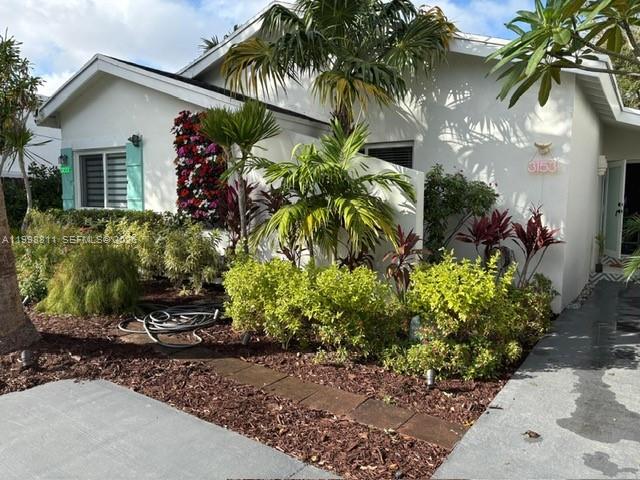 3155 Jackson Avenue Miami, FL 33133 - Photo 3 of 20 a front view of a house with a yard and potted plants