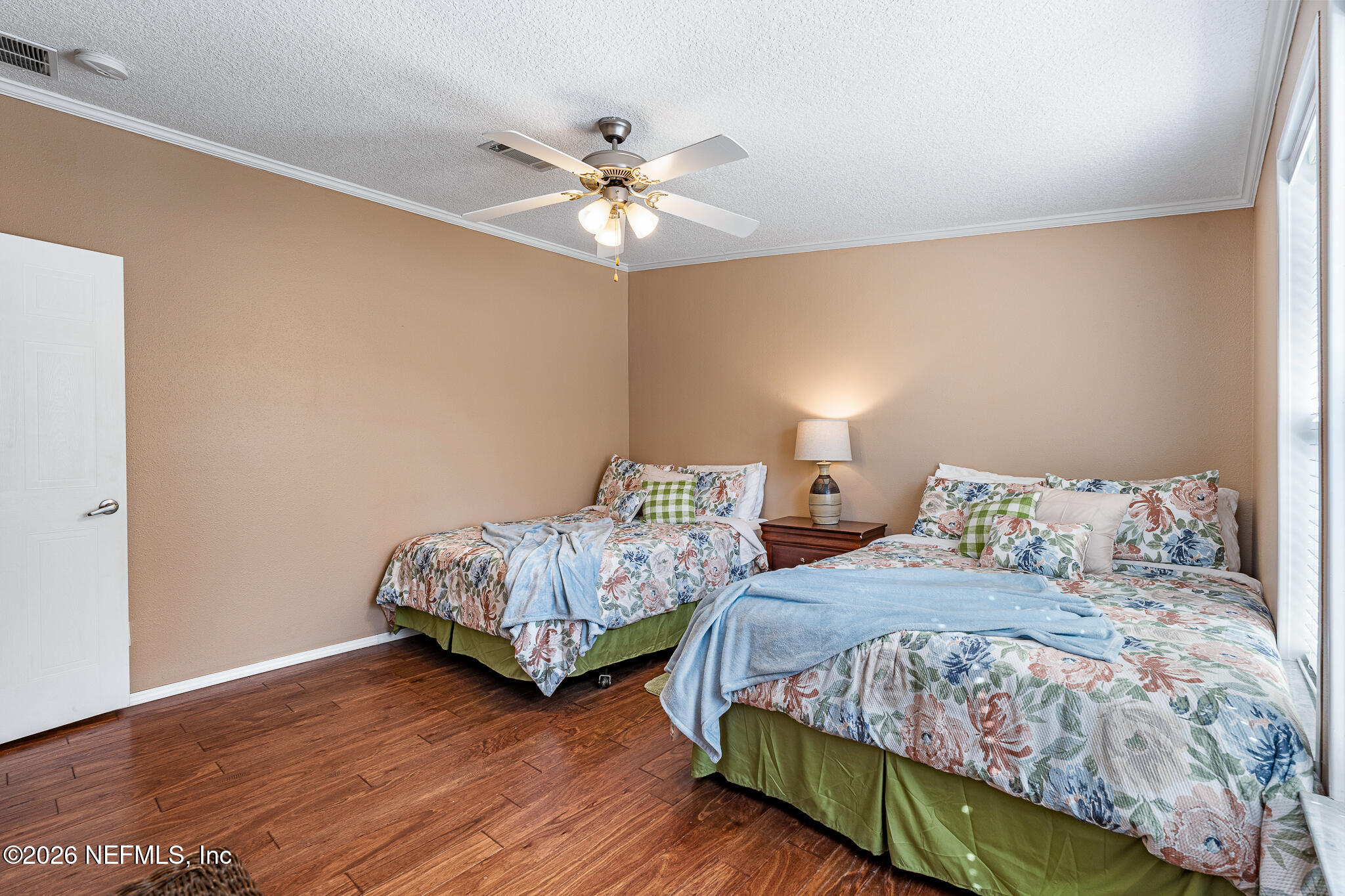 105 South Lake George Drive Georgetown, FL 32139 - Photo 21 of 30 a bedroom with two beds and a chandelier