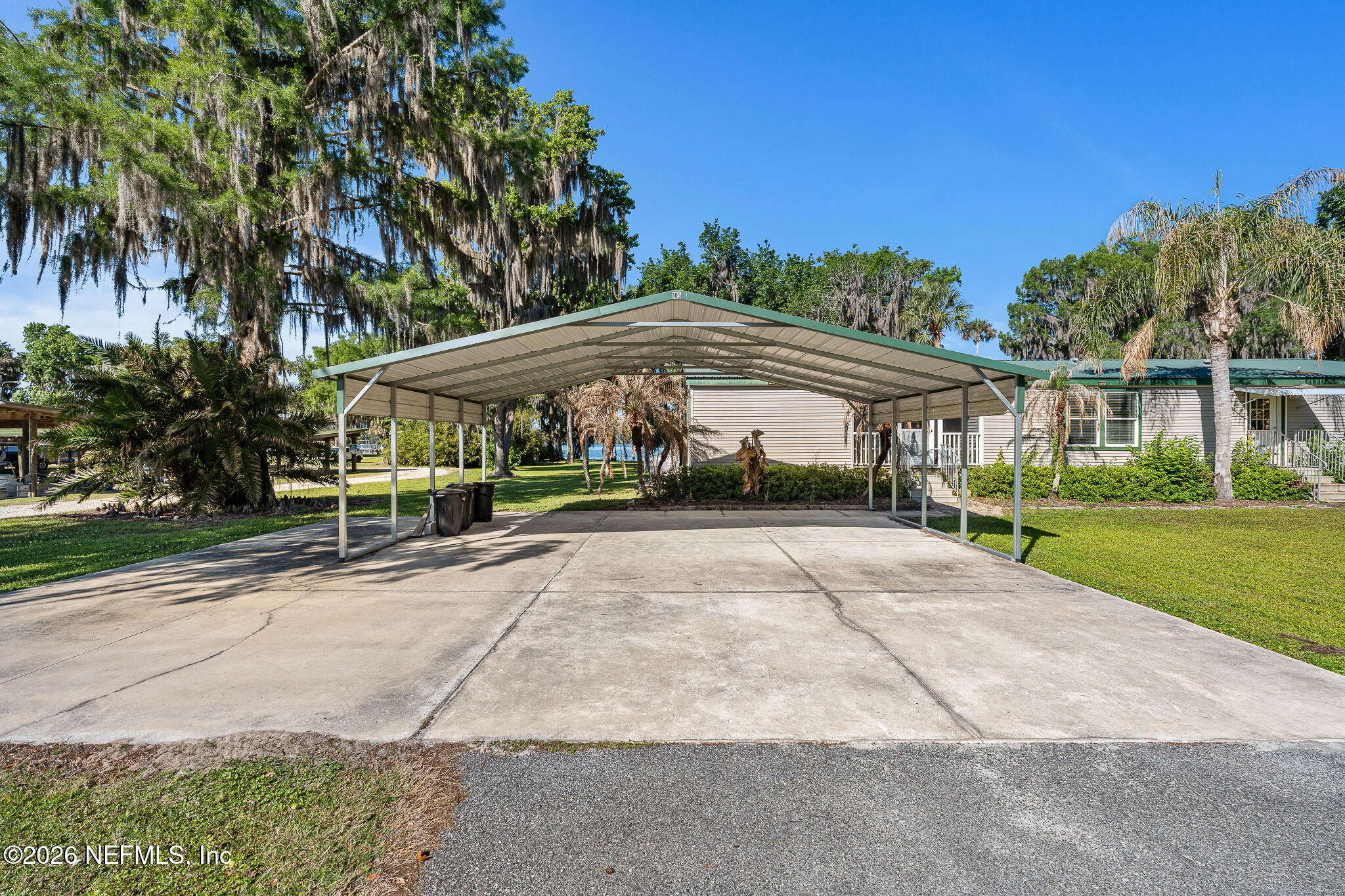 105 South Lake George Drive Georgetown, FL 32139 - Photo 30 of 30 a view of patio with a table and chairs under an umbrella