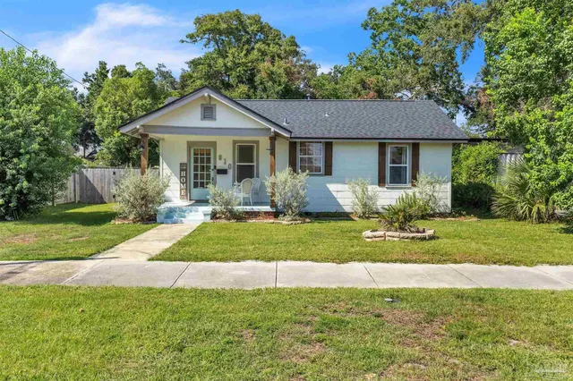 a front view of a house with a yard and porch