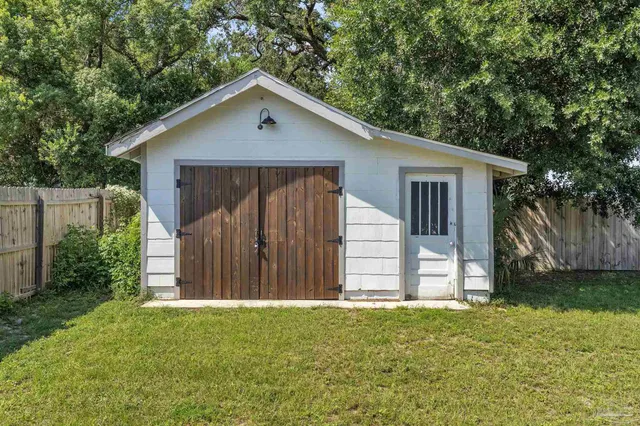 a front view of house with a garden