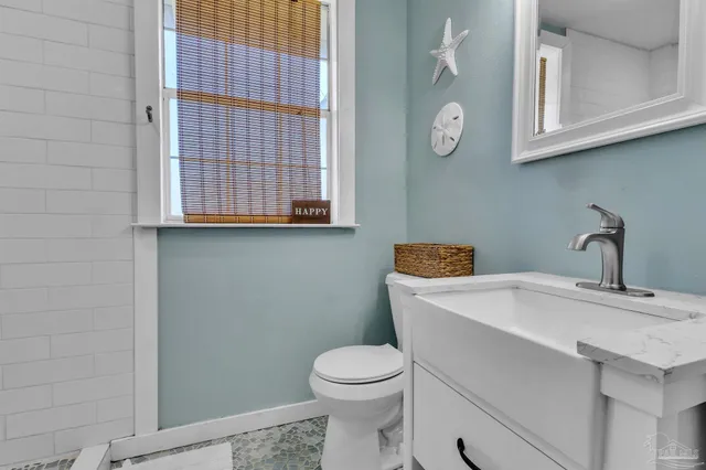 a bathroom with a toilet a sink and a window