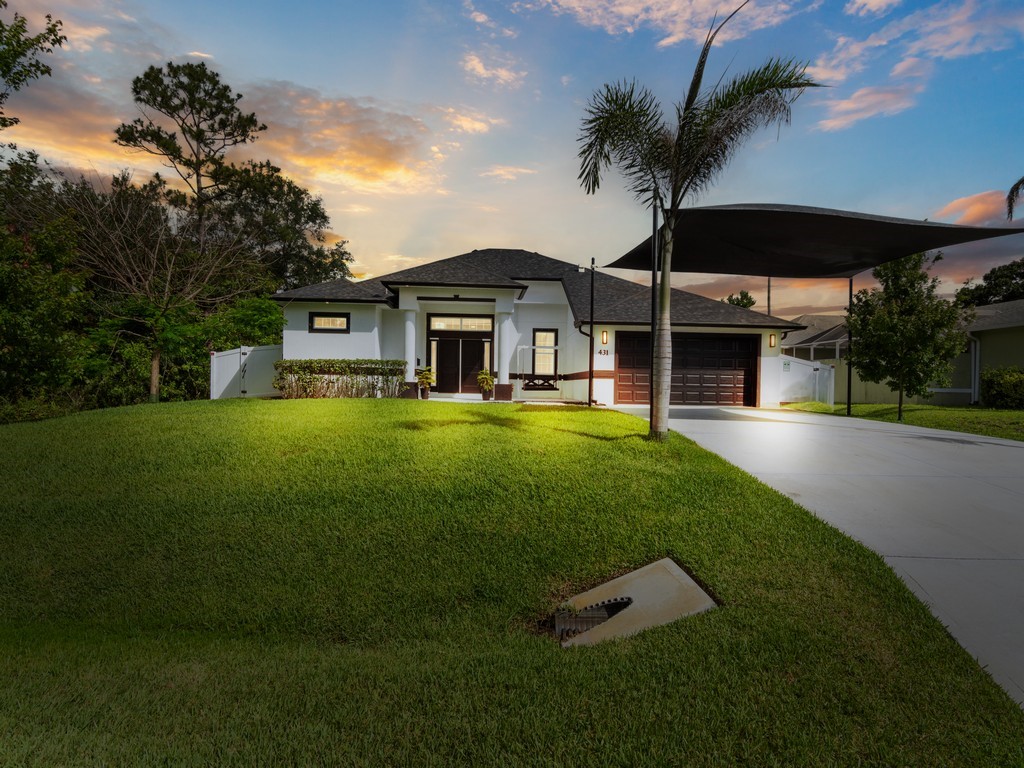 431 Midvale Terrace Sebastian, FL 32958 - Photo 1 of 34 a front view of a house with a yard table and chairs