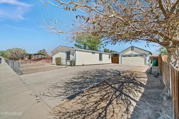 a view of house with backyard and parking