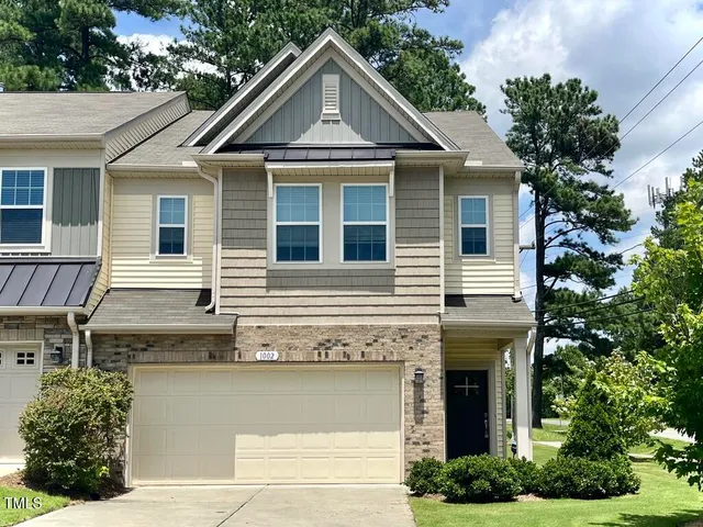 a front view of a house with plants