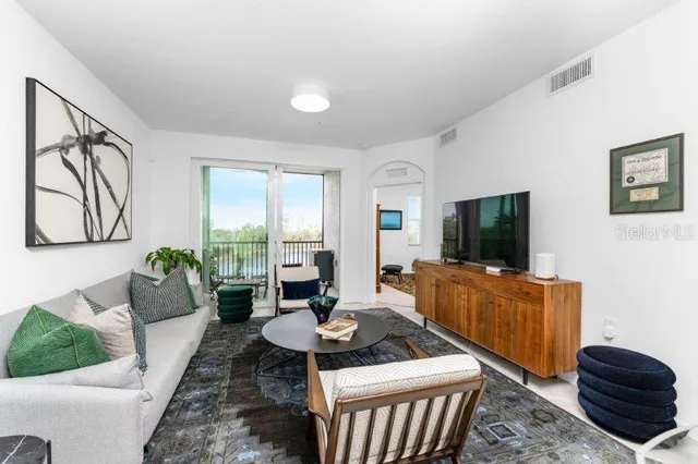 a living room with furniture and a flat screen tv