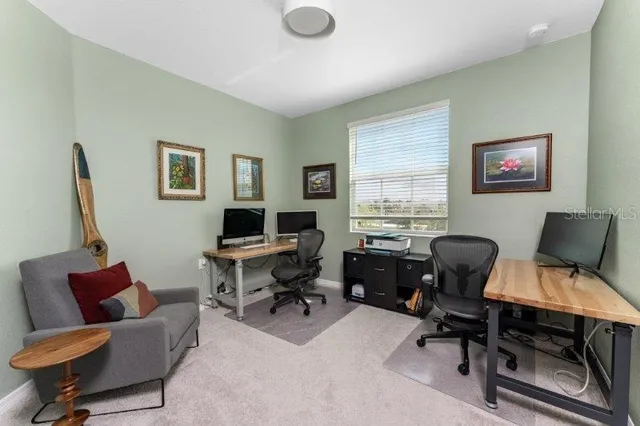 a view of workspace with a window and lounge chair