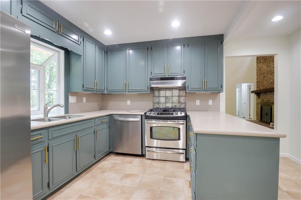 765 Spring Valley Drive Cumming, GA 30041 - Photo 13 of 31 a kitchen with kitchen island granite countertop appliances cabinets and a sink