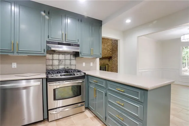 a kitchen with stove cabinets and a sink
