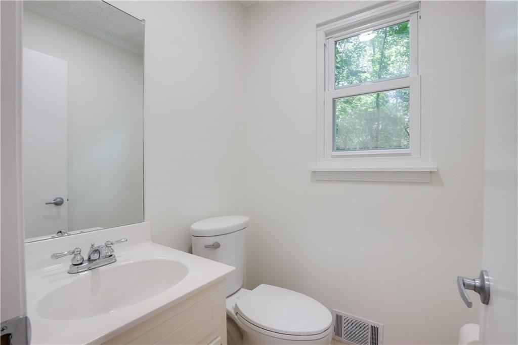 765 Spring Valley Drive Cumming, GA 30041 - Photo 16 of 31 a white toilet sitting next to a bathroom sink