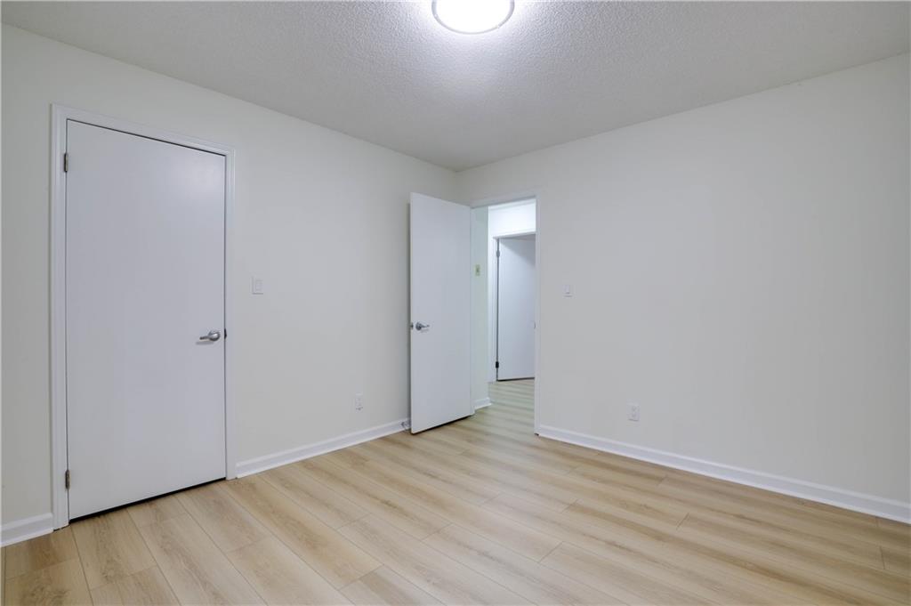 765 Spring Valley Drive Cumming, GA 30041 - Photo 22 of 31 a view of an empty room with wooden floor