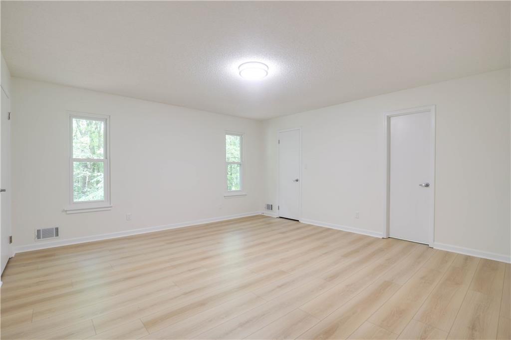 765 Spring Valley Drive Cumming, GA 30041 - Photo 23 of 31 an empty room with wooden floor and windows