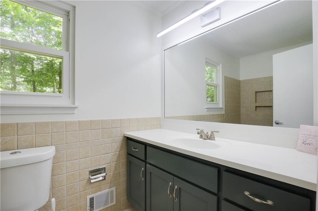 765 Spring Valley Drive Cumming, GA 30041 - Photo 25 of 31 a bathroom with a sink and a mirror