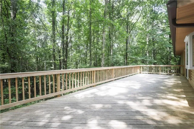 a view of balcony with wooden floor and fence
