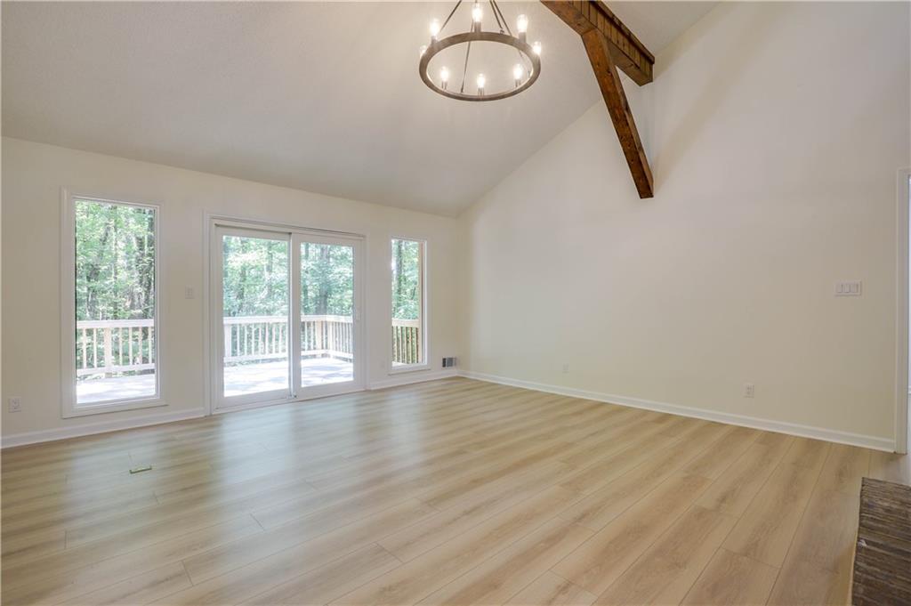 765 Spring Valley Drive Cumming, GA 30041 - Photo 5 of 31 an empty room with wooden floor and windows
