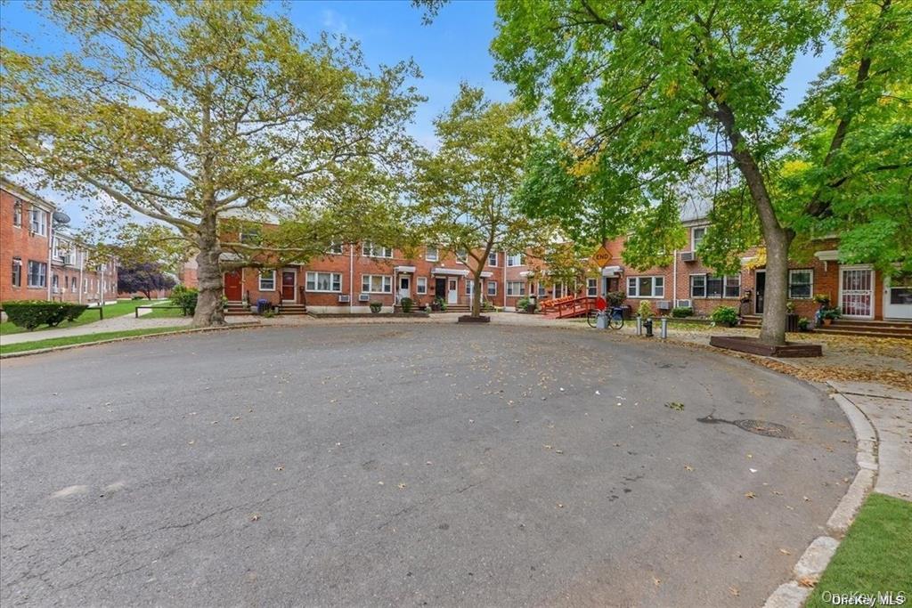 68-02 140th Street, Unit A Queens, NY 11367 - Photo 16 of 16 View of asphalt road with curbs, sidewalks, and a residential view