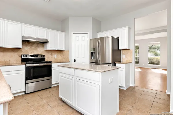 a kitchen with stainless steel appliances a stove a sink and a refrigerator