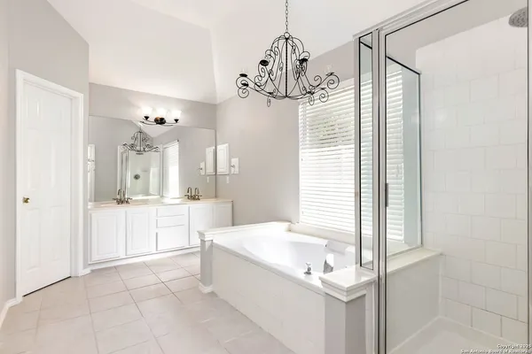 a spacious bathroom with a sink a mirror and a shower