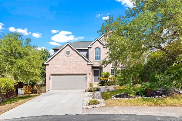 a stone house with yard in front of it