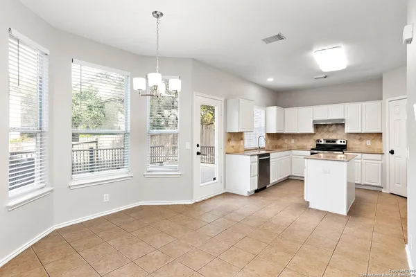 a kitchen with white cabinets and white appliances