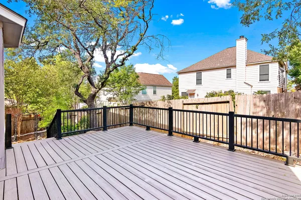 a view of a house with a wooden deck