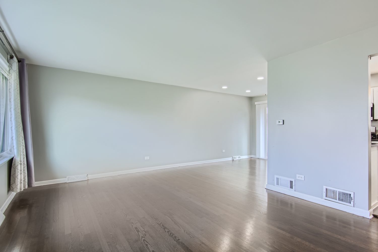 10403 Barnard Drive Chicago Ridge, IL 60415 - Photo 3 of 25 a view of an empty room with wooden floor and a window