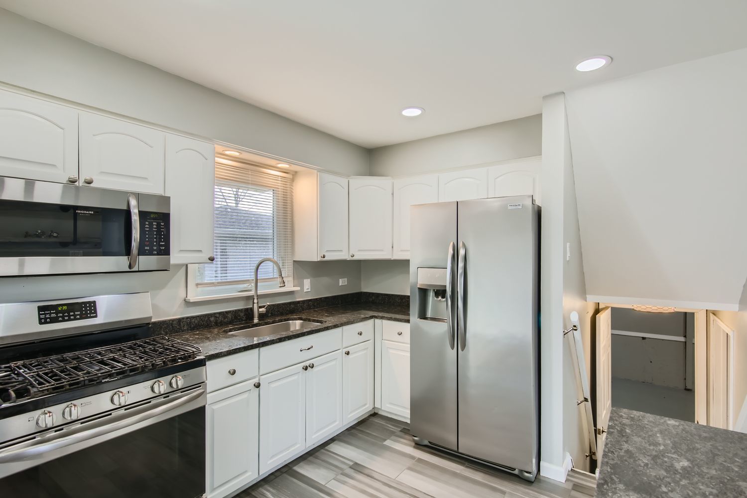 10403 Barnard Drive Chicago Ridge, IL 60415 - Photo 8 of 25 a kitchen with granite countertop a refrigerator stove and microwave