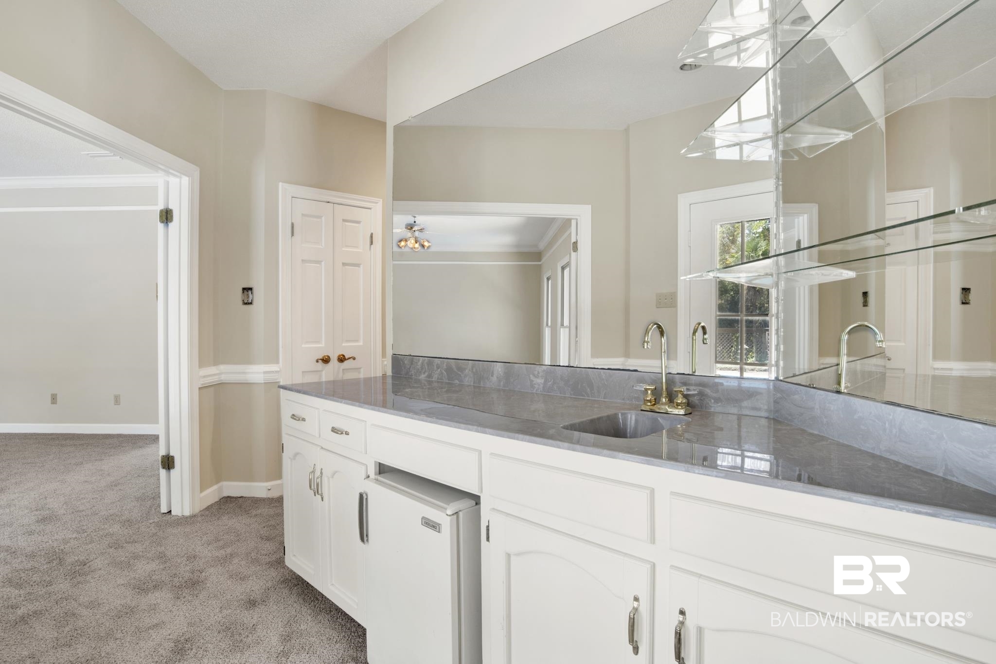 6805 Hunters Court Mobile, AL 36695 - Photo 12 of 37 Kitchen with light colored carpet, a sink, white cabinets, and baseboards