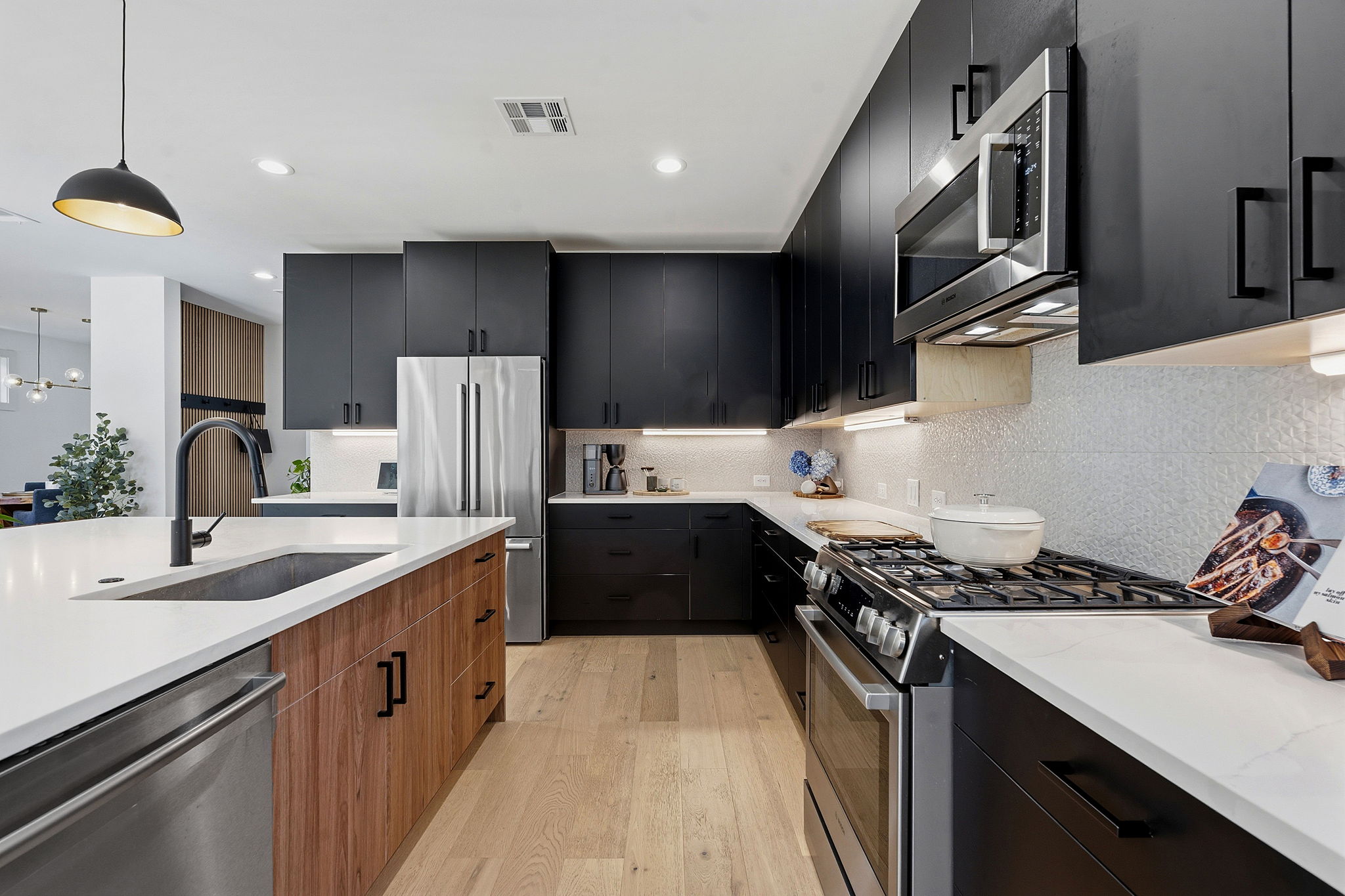 4313 Jinx Avenue, Unit 1 Austin, TX 78704 - Photo 9 of 40 Kitchen featuring stainless steel appliances, light wood-style flooring, light stone counters, dual tone cabinetry, and modern cabinets