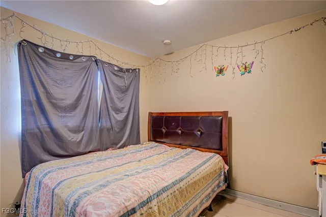 a bedroom with a bed and a mirror