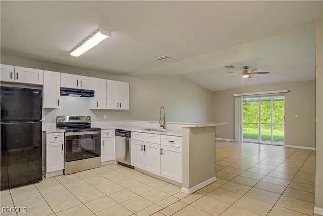 a kitchen with stainless steel appliances a stove sink and cabinets