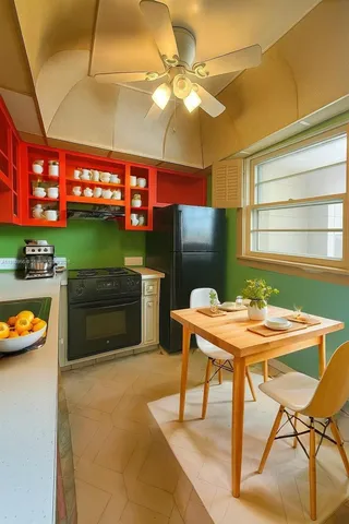 a table and chairs in a open kitchen