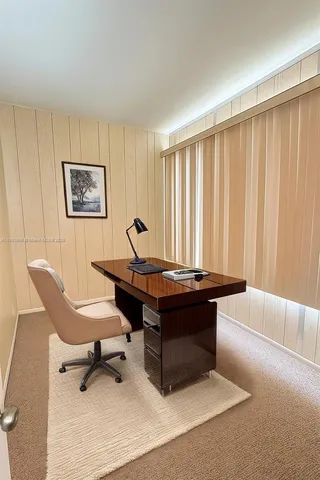 a living room with a table and a piano