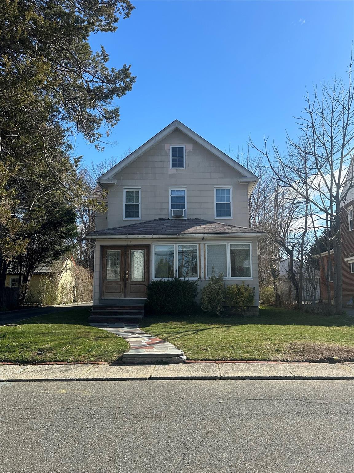 a front view of a house with a garden