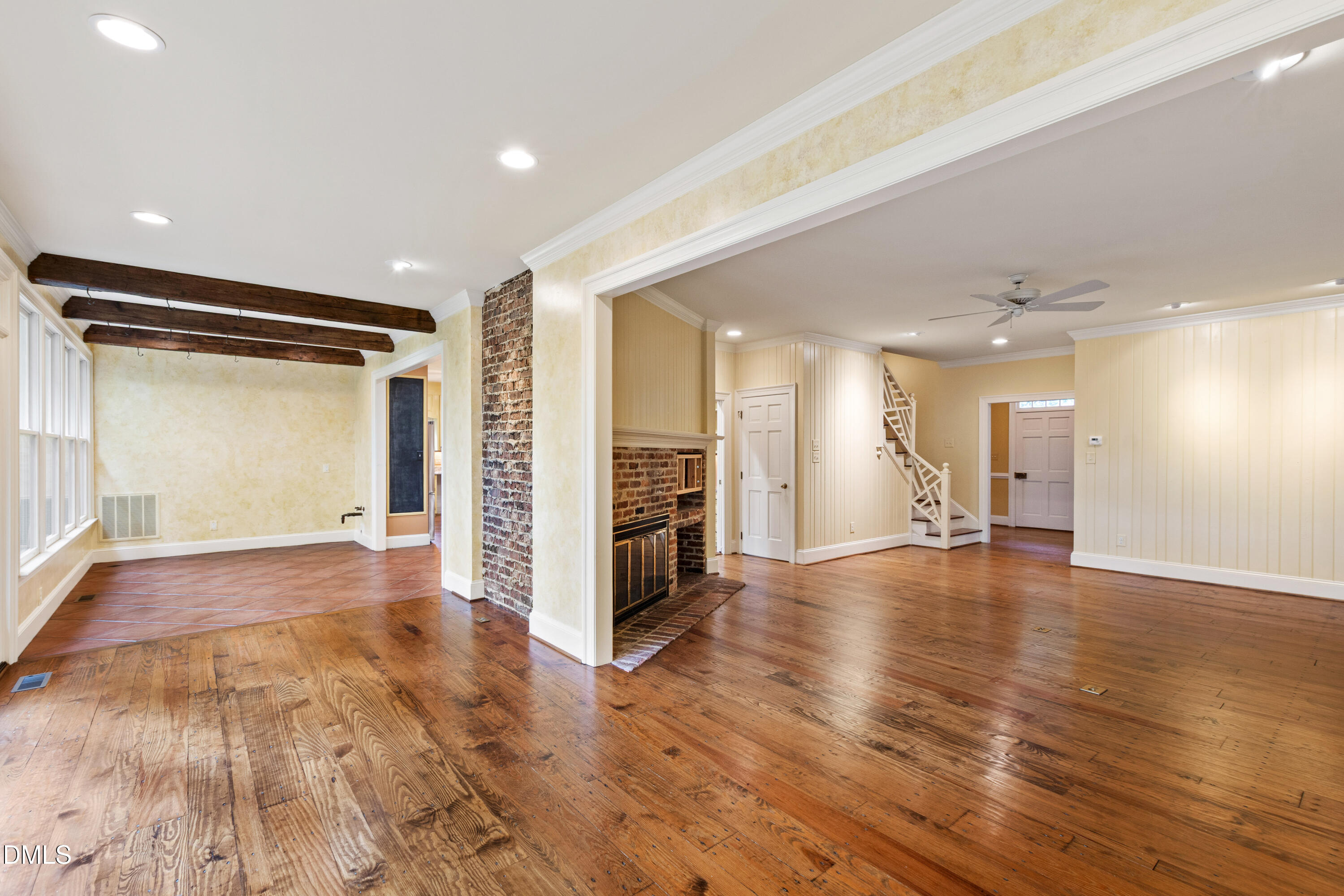 3324 Landor Road Raleigh, NC 27609 - Photo 12 of 69 a view of an empty room with wooden floor and a kitchen