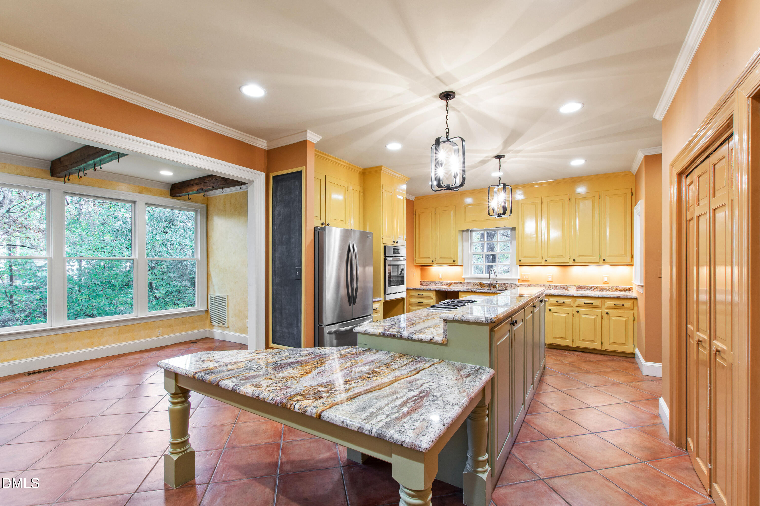 3324 Landor Road Raleigh, NC 27609 - Photo 15 of 69 a kitchen with a sink a counter top space and stainless steel appliances