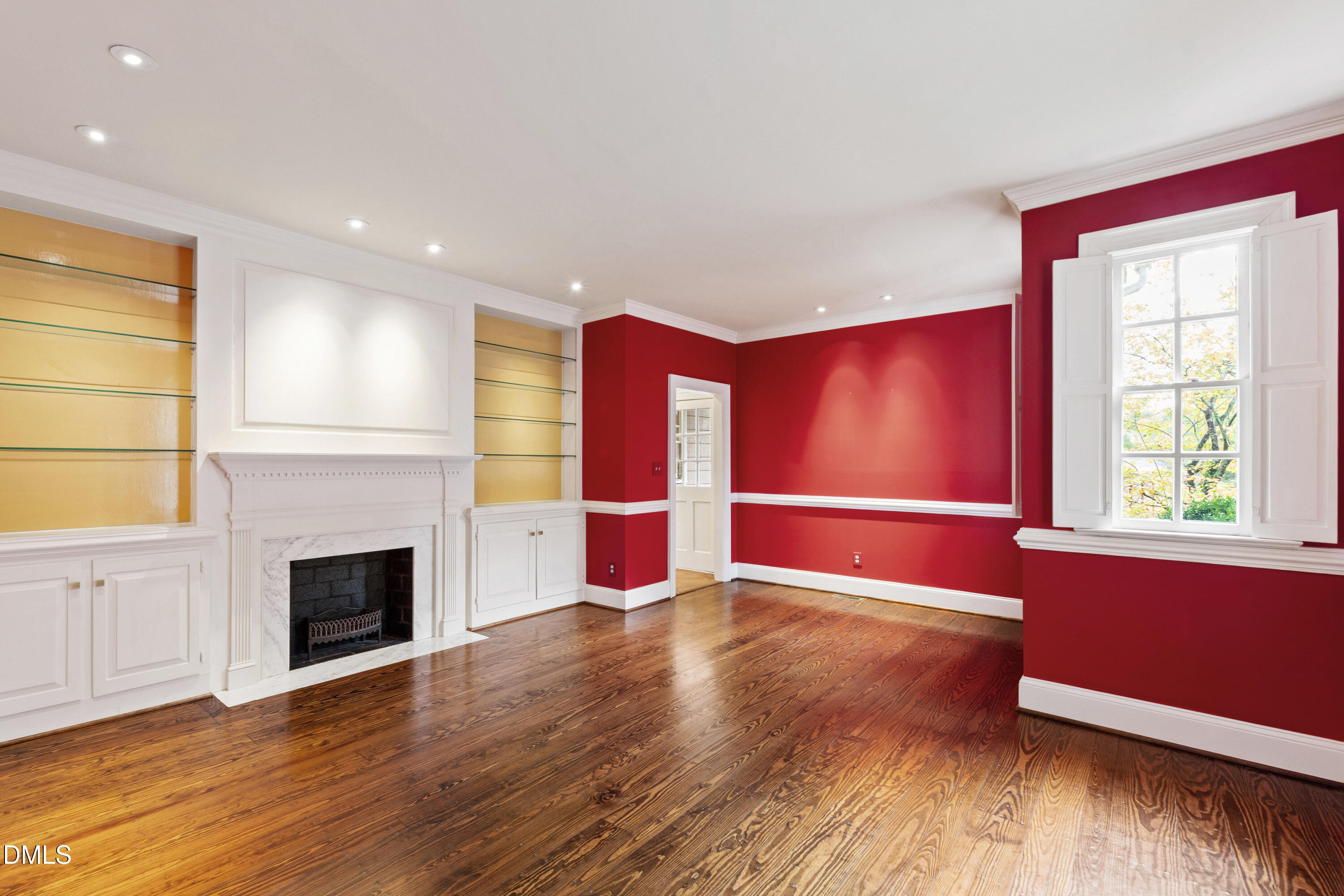 3324 Landor Road Raleigh, NC 27609 - Photo 24 of 69 a view of empty room with wooden floor and fireplace