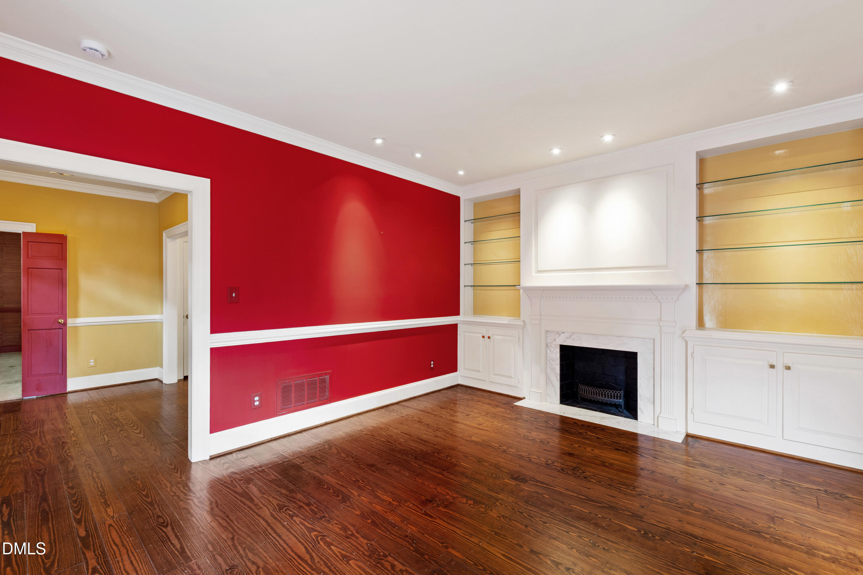 3324 Landor Road Raleigh, NC 27609 - Photo 25 of 69 a view of an empty room with wooden floor a fireplace and a window