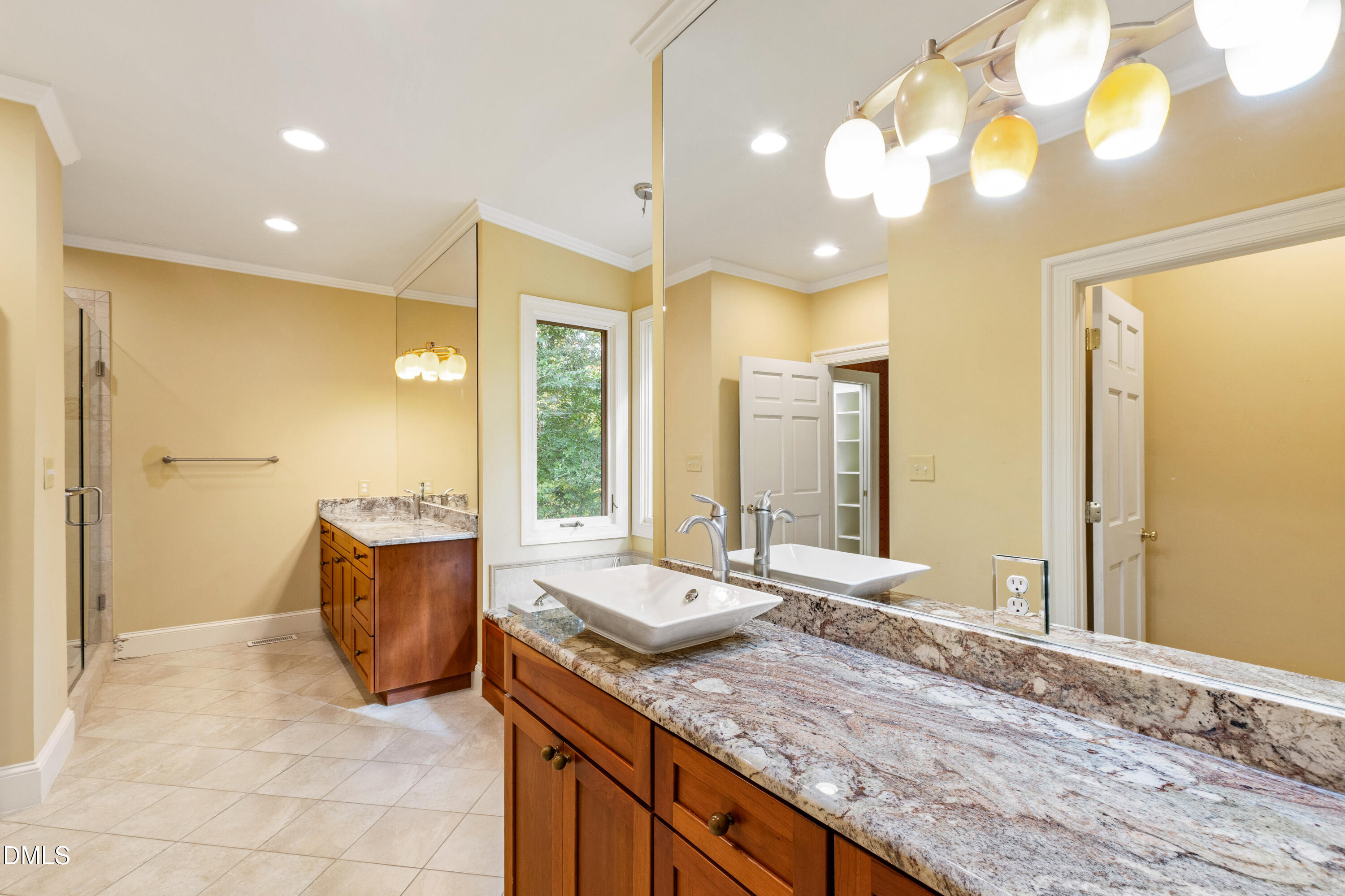3324 Landor Road Raleigh, NC 27609 - Photo 33 of 69 a spacious bathroom with a granite countertop sink and a mirror