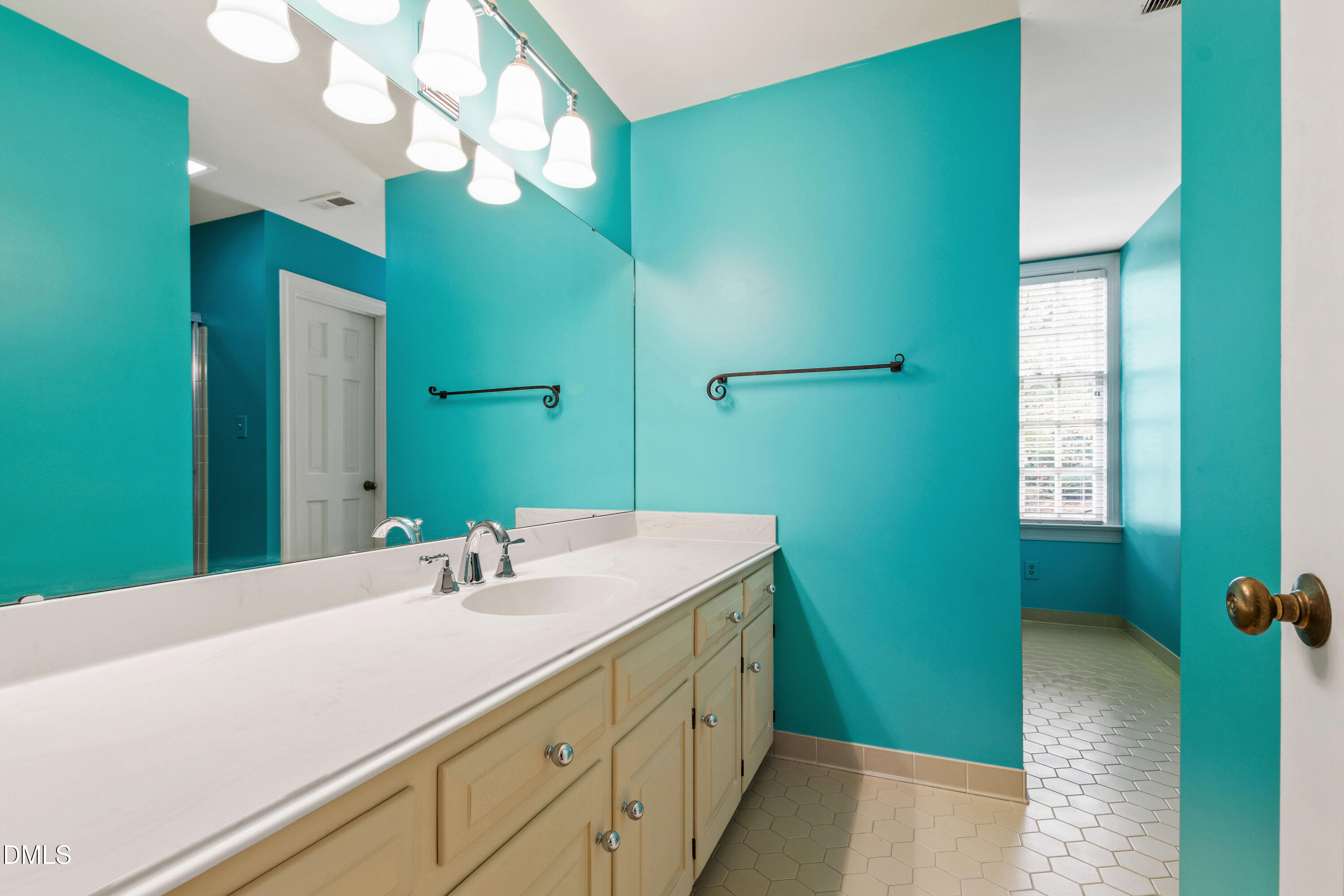 3324 Landor Road Raleigh, NC 27609 - Photo 40 of 69 a bathroom with a sink and a mirror